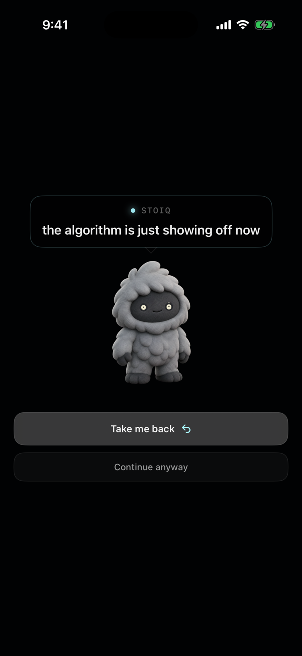 The Stoiq interruption on iPhone: the companion has climbed up the screen and says “the algorithm is just showing off now”, above two buttons reading Take me back and Continue anyway.